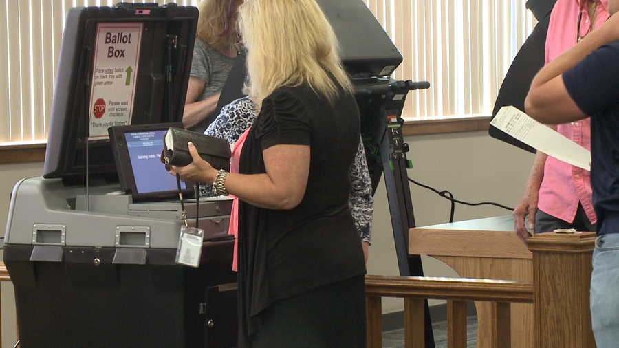 Voter submitting her ballot in Fayetteville during the 2018 Primaries