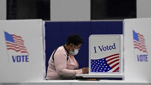 In this Nov. 3, 2020, file photo, a woman votes at the MLB Urban Youth Academy in Kansas City, Mo.