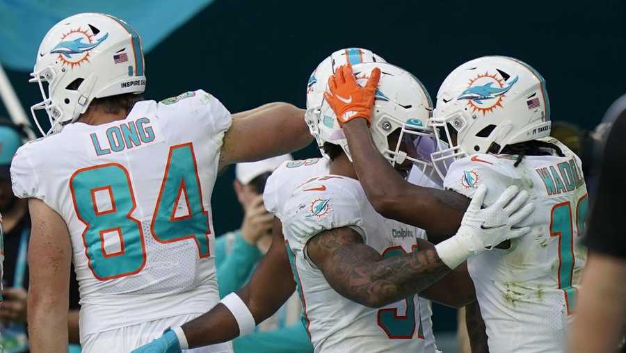 miami dolphins running back myles gaskin (37) celebrates with teammate jaylen waddle (17) after scoring a touchdown during the second half of an nfl football game against the carolina panthers, sunday, nov. 28, 2021, in miami gardens, fla. (ap photo/lynne sladky)