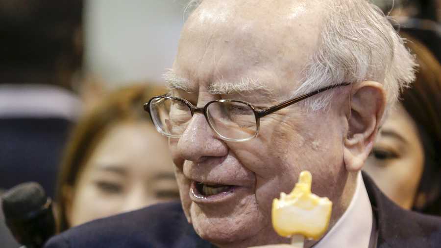 Warren Buffett, Berkshire Hathaway Chairman and CEO, eats an ice cream bar as he tours the exhibit floor at the CenturyLink Center in Omaha, Neb., Saturday, May 6, 2017, where company subsidiaries display their products. More than 30,000 people are expected to attend the annual Berkshire Hathaway shareholders meeting where Buffett and his Vice Chairman Charlie Munger preside over a Q&A session.