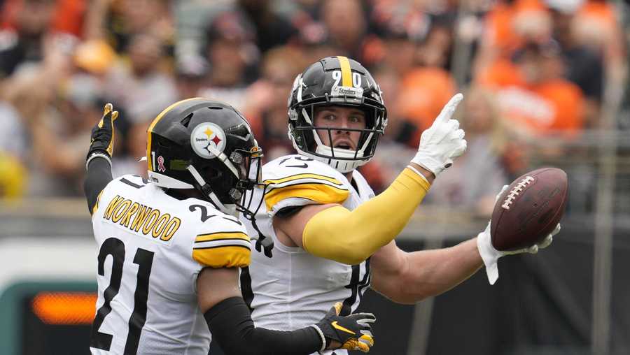 Pittsburgh Steelers linebacker T.J. Watt (90) celebrates after an interception with safety Tre Norwood (21) during the first half of an NFL football game against the Cincinnati Bengals, Sunday, Sept. 11, 2022, in Cincinnati.