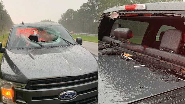 lightning causes chunk of roadway to go flying into truck.