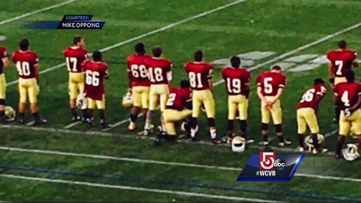 High school football player kneels during national anthem