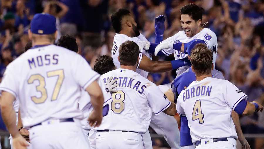 Kansas City Royals' Whit Merrifield, top right, is mobbed by teammates after hitting a walk-off two-run double during the ninth inning of the team's baseball game against the Toronto Blue Jays Friday, June 23, 2017, in Kansas City, Mo. The Royals won 5-4. (AP Photo/Charlie Riedel)
