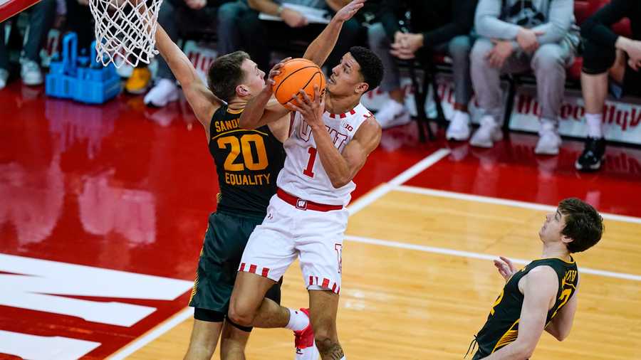 Wisconsin's Johnny Davis (1) shoots against Iowa's Payton Sandfort (20) during the first half of an NCAA college basketball game Thursday, Jan. 6, 2022, in Madison, Wis. Wisconsin won 87-78.