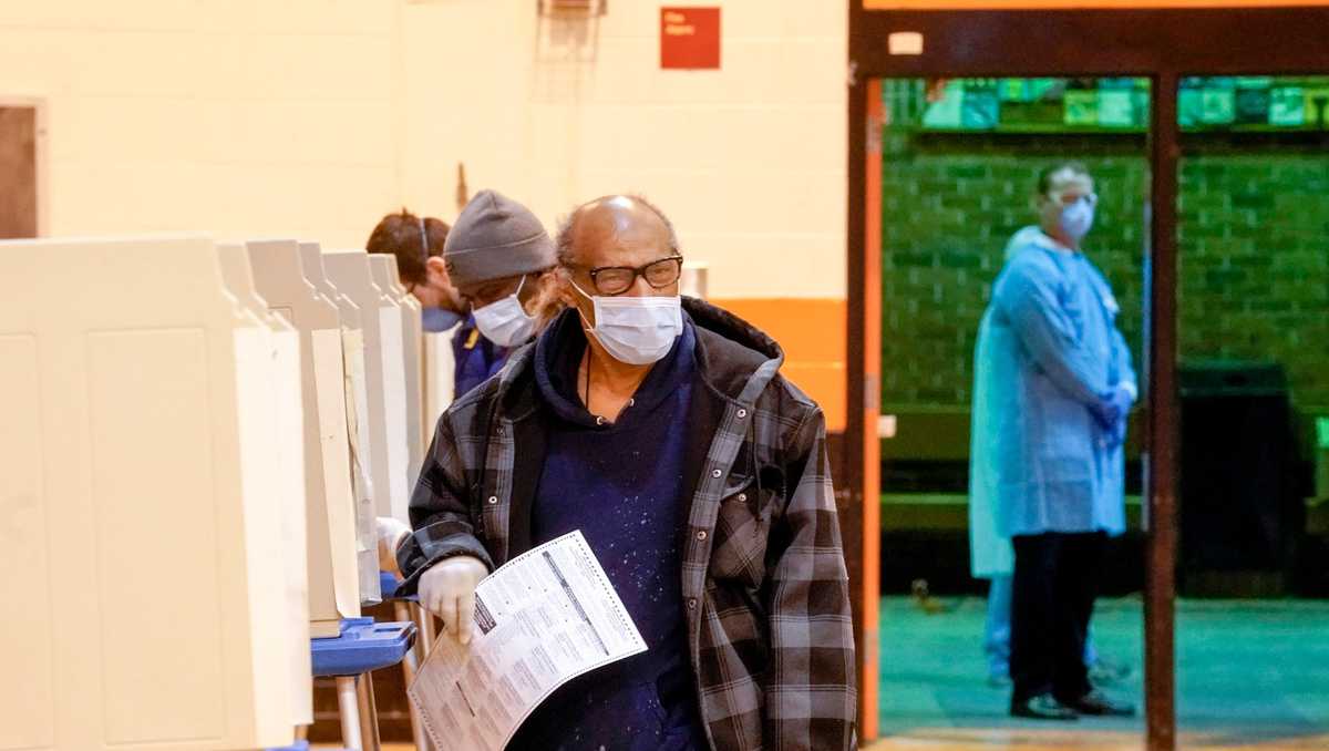 Wisconsin voters wait for hours, others stay home amid virus