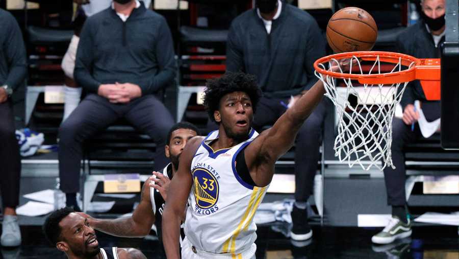 NEW YORK, NEW YORK - DECEMBER 22: James Wiseman #33 of the Golden State Warriors attempts a layup against Jeff Green #8 and Kyrie Irving #11 of the Brooklyn Nets during the first half at Barclays Center on December 22, 2020 in the Brooklyn borough of New York City. NOTE TO USER: User expressly acknowledges and agrees that, by downloading and/or using this photograph, user is consenting to the terms and conditions of the Getty Images License Agreement.  (Photo by Sarah Stier/Getty Images)
