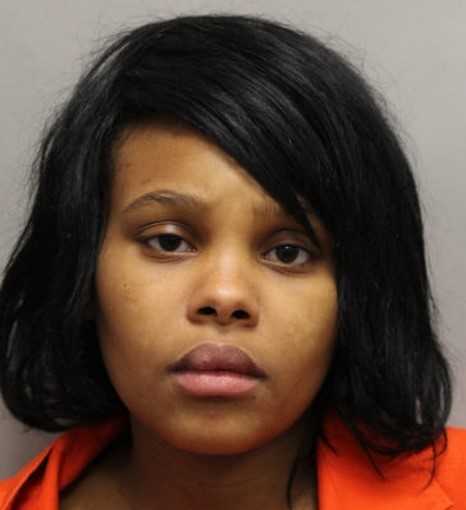 Woman accused of robbing a victim at gunpoint with 3 children present