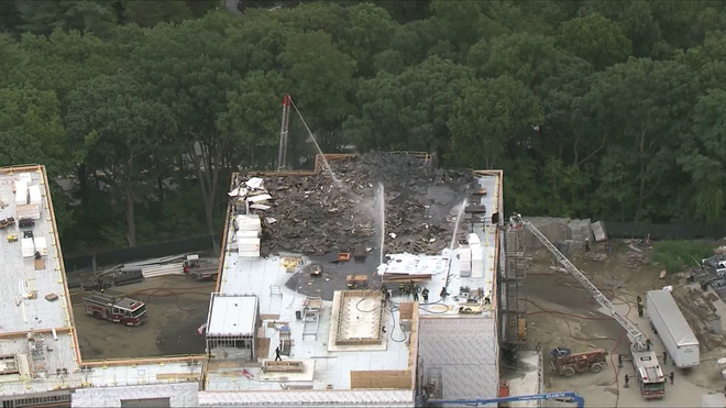 a photo of the damage following a fire on the roof of the  x20;worcester doherty high school under construction