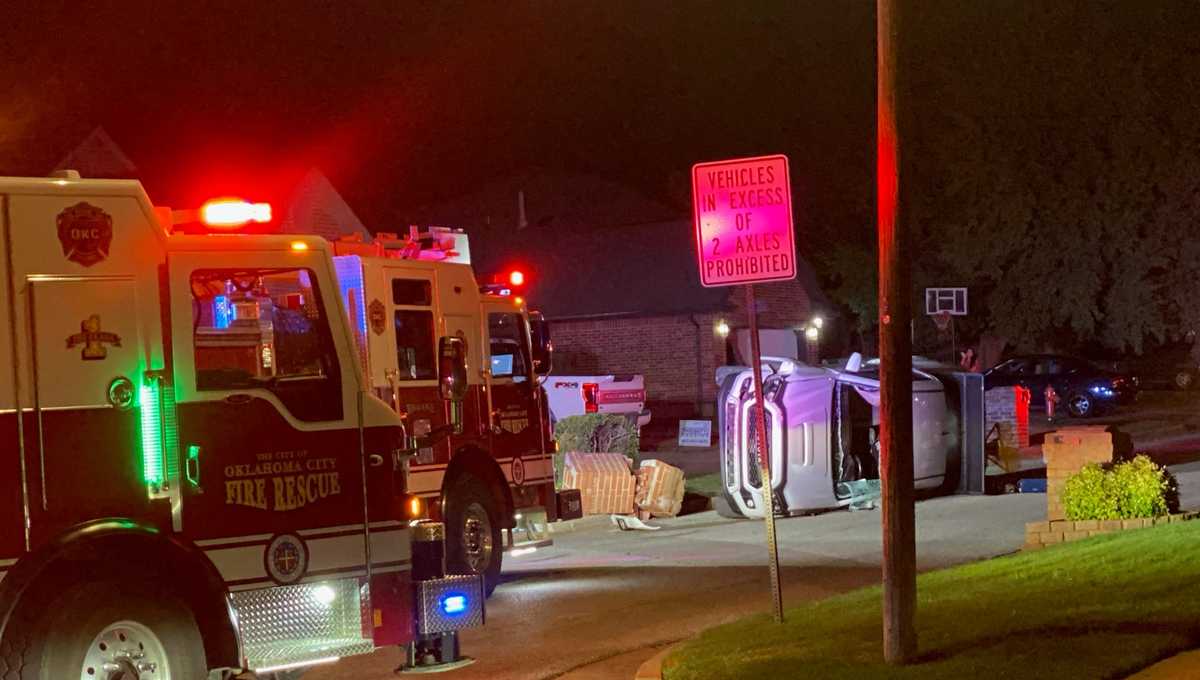 Rescue workers provide assistance after a rollover accident in northwest Oklahoma City