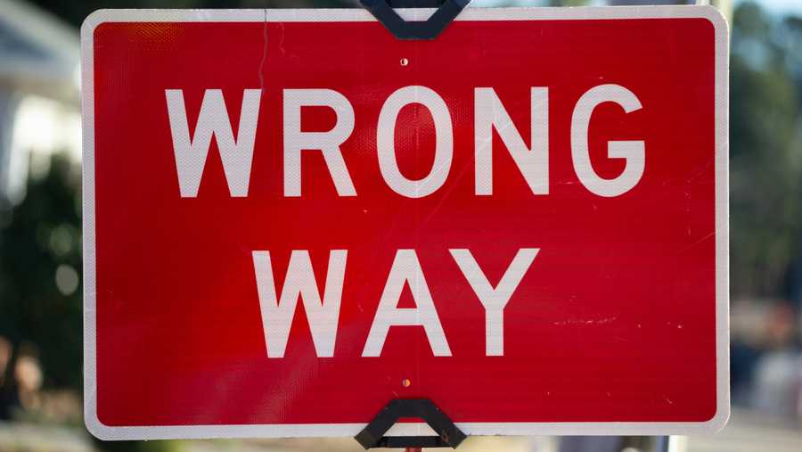 Red and white wrong way sign