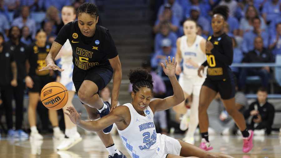 West Virginia&apos;s Sydney Shaw (5) gathers a loose ball ahead of North Carolina&apos;s Indya Nivar (24) during the first half in the second round of the NCAA college basketball tournament in Chapel Hill, N.C., Monday, March 24, 2025.