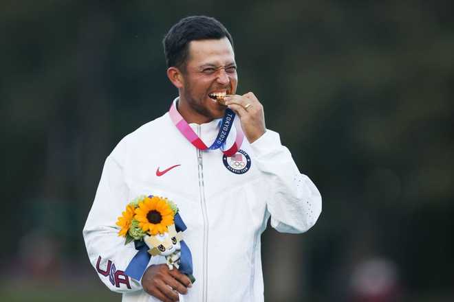 Gold&#x20;medalist&#x20;Xander&#x20;Schauffele&#x20;of&#x20;the&#x20;United&#x20;States&#x20;bites&#x20;his&#x20;medal&#x20;during&#x20;the&#x20;awarding&#x20;ceremony&#x20;of&#x20;the&#x20;men&amp;apos&#x3B;s&#x20;individual&#x20;stroke&#x20;play&#x20;of&#x20;golf&#x20;match&#x20;at&#x20;Tokyo&#x20;2020&#x20;Olympics&#x20;in&#x20;Saitama,&#x20;Japan,&#x20;Aug.&#x20;1,&#x20;2021.&#x20;&#x28;Photo&#x20;by&#x20;Zheng&#x20;Huansong&#x2F;Xinhua&#x20;via&#x20;Getty&#x20;Images&#x29;