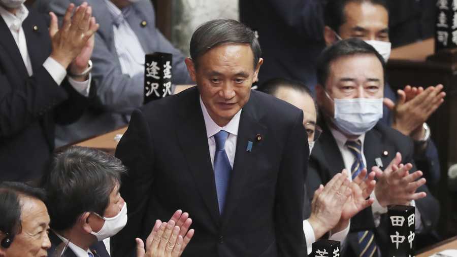 Yoshihide Suga is applauded after being elected as Japan's new prime minister at parliament's lower house in Tokyo, Wednesday, Sept. 16, 2020.