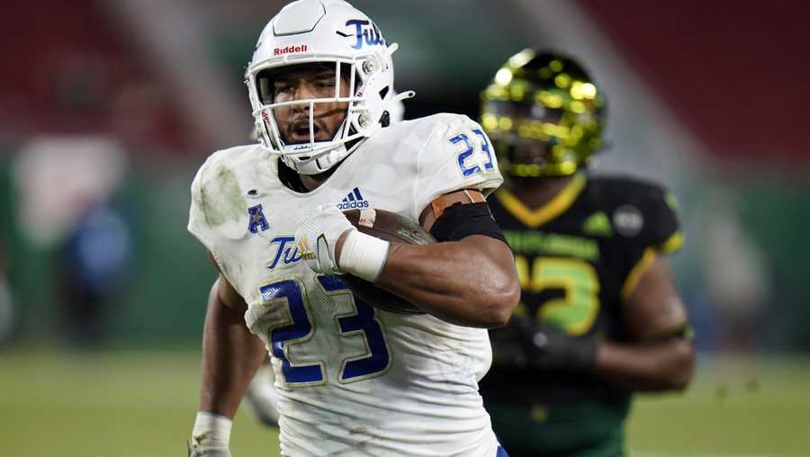 Tulsa linebacker Zaven Collins (23) runs back an interception for a score against South Florida during the second half of an NCAA college football game in Tampa, Fla., in this Friday, Oct. 23, 2020, file photo. Zaven Collins is a small-town player with big-time talent. He was overlooked after a stellar high school career in Hominy, Okla., a town with about 3,500 people. He’s got the nation’s attention now -- the 6-foot-4, 260-pound linebacker is a finalist for the Butkus and Nagurski Awards. (AP Photo/Chris O'Meara, File)
