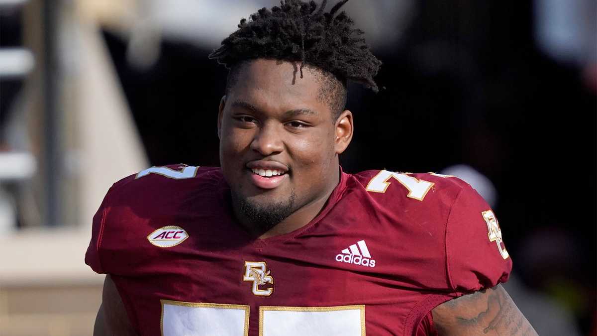 Boston College offensive guard Zion Johnson holds a team jersey