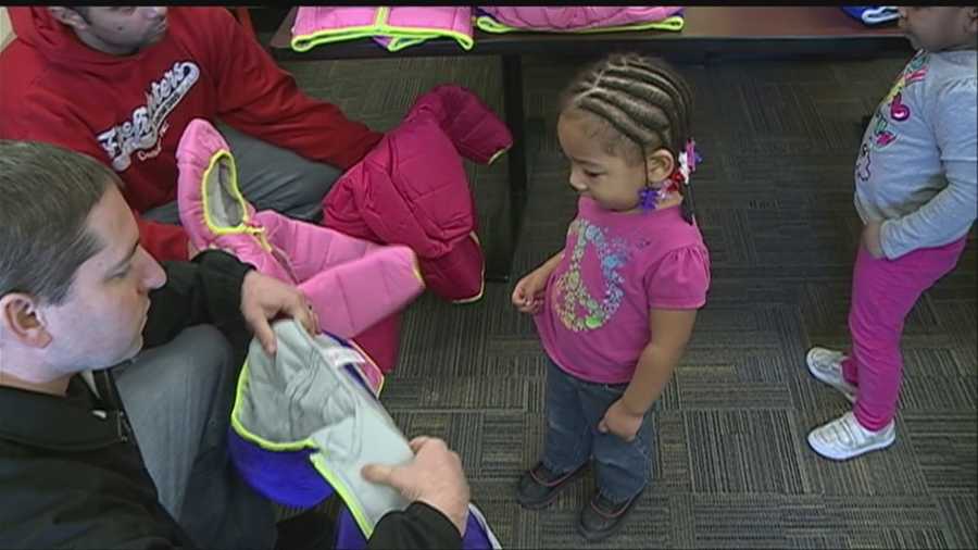 Firefighters were on hand to deliver warm coats to children at Conestoga Elementary on Tuesday.