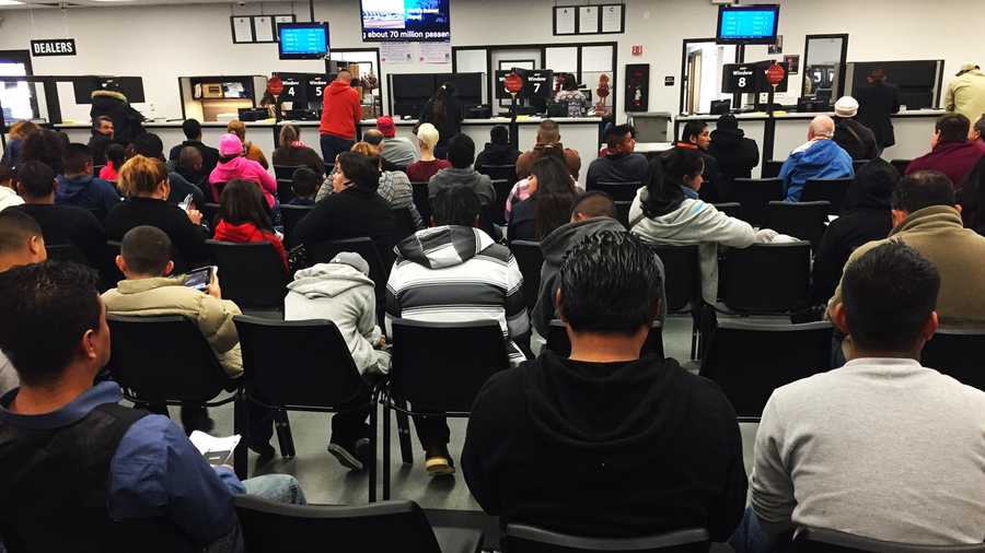 People wait in a DMV office in Salinas on Friday.  Jan. 2, 2014