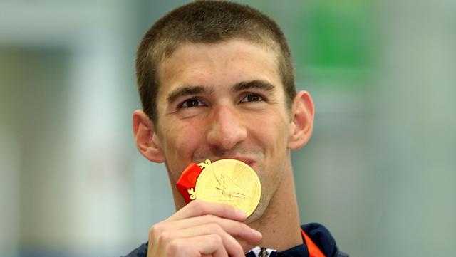 Michael Phelps of the United States poses with the gold medal during the medal ceremony for the Men's 4 x 100m Freestyle Relay held at the National Aquatics Center on Day 3 of the Beijing 2008 Olympic Games on August 11, 2008 in Beijing, China.