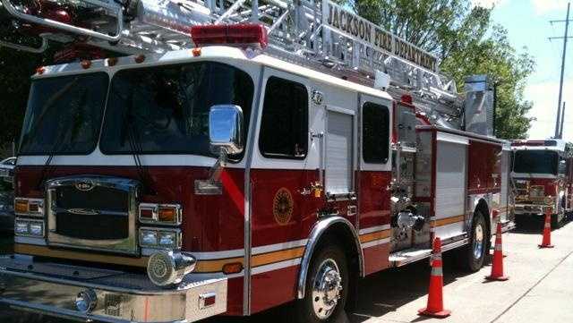 Jackson fire crews work to put out flames at a home on Woodard Street