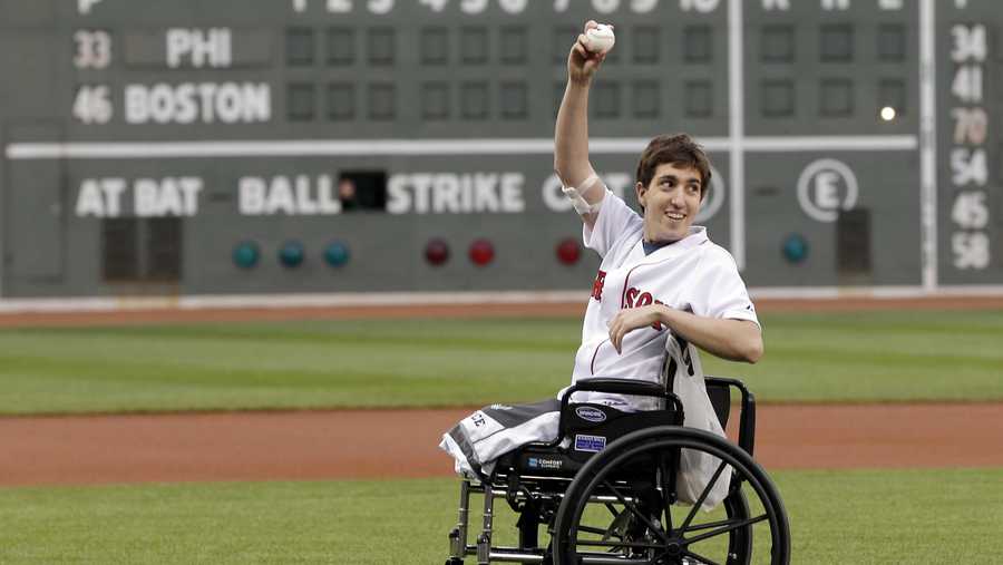 Boston Marathon bombing survivor Jeff Bauman acknowledges cheering fans before throwing out the ceremonial first pitch at Fenway Park prior to a baseball between the Boston Red Sox and the Philadelphia Phillies Tuesday, May 28, 2013, in Boston.