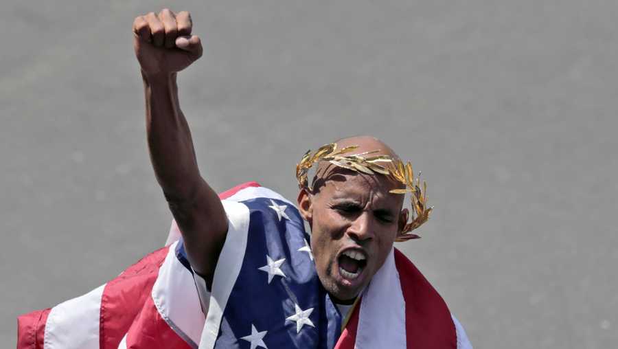 With an American flag wrapped around him, Meb Keflezighi celebrates his victory in the 118th Boston Marathon Monday, April 21, 2014 in Boston.