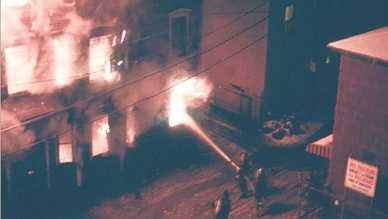 Lowell firefighters battle a five-alarm blaze on Decatur Street in the Acre section in March 1982 that left eight people dead.