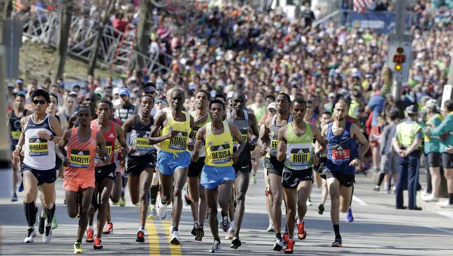 Defending champion Lelisa Desisa, of Ethiopia, center, runs at the head of the pack in the 120th Boston Marathon.