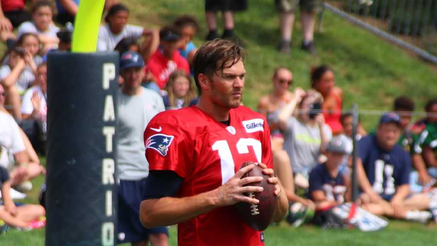 Patriots quarterback Tom Brady tosses passes with wide receiver Julian Edelman during a break in the action.