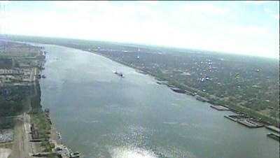 Jefferson Parish fire crew investigating barge fire on Mississippi River near Huey P. Long Bridge
