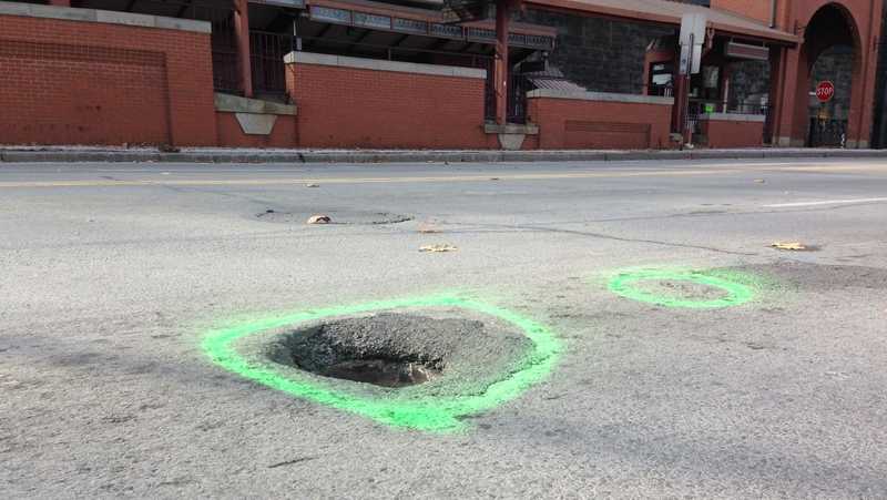A pothole was marked with spray paint during the accident reconstruction investigation on East Carson Street.