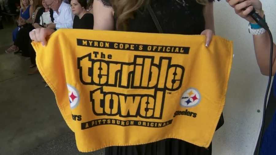 A Pittsburgh fan holds a Terrible Towel to support the Steelers.