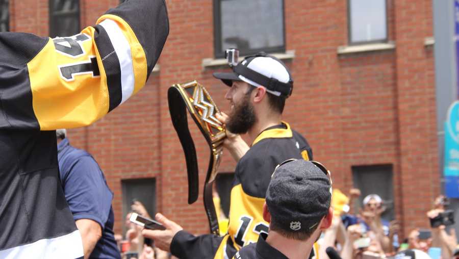 Nick Bonino carries a Penguins WWE championship belt at the 2016 Stanley Cup parade.