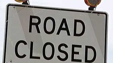 sign that says "road closed"
