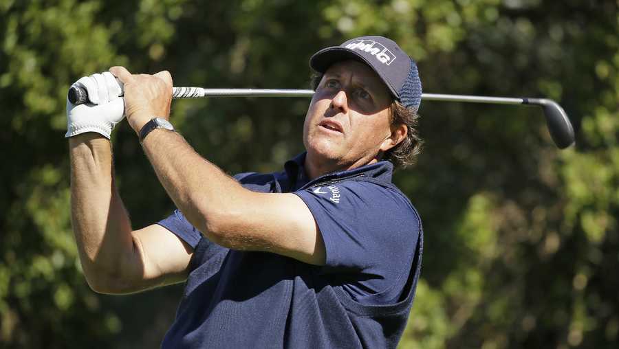 Phil Mickelson hits from the 16th tee of the Pebble Beach Golf Links during the third round of the AT&T Pebble Beach National Pro-Am golf tournament Saturday, Feb. 13, 2016, in Pebble Beach, Calif.