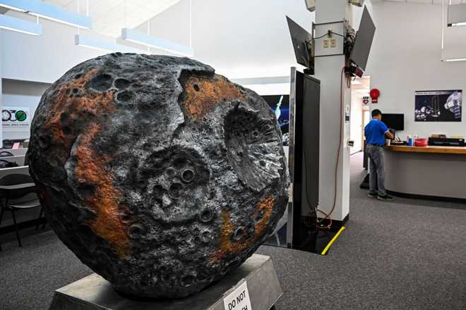 A model of the metal-rich asteroid named Psyche is displayed at the media center in NASA's Kennedy Space Center in Cape Canaveral, Florida, on October 10, 2023. NASA and SpaceX are targeting October 12, 2023, at 10:16 a.m. EDT for launch of the Psyche mission from Kennedy Space Center to the main asteroid belt between Mars and Jupiter. (Photo by CHANDAN KHANNA / AFP) (Photo by CHANDAN KHANNA/AFP via Getty Images)
