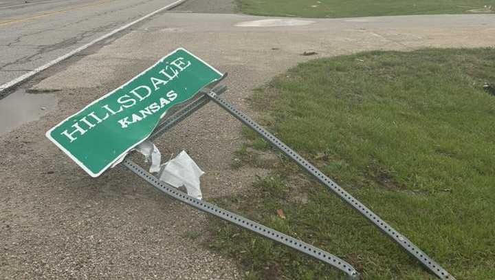 A sign for Hillsdale, Kansas, is seen crumpled and on the ground after April 13, 2026, tornado-warned storms.