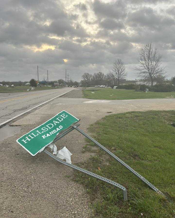 A sign for Hillsdale, Kansas, is seen crumpled and on the ground after April 13, 2026, tornado-warned storms.