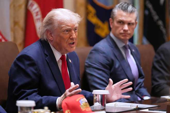President Donald Trump speaks during a Cabinet meeting at the White House, Wednesday, May 27, 2026, in Washington, as Secretary of Defense Pete Hegseth looks on.