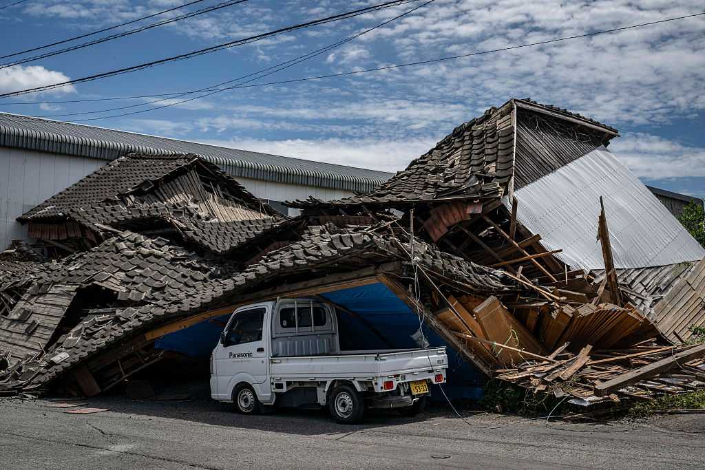 Rescuers search for survivors after a 7.1 quake kills 18 in Japan