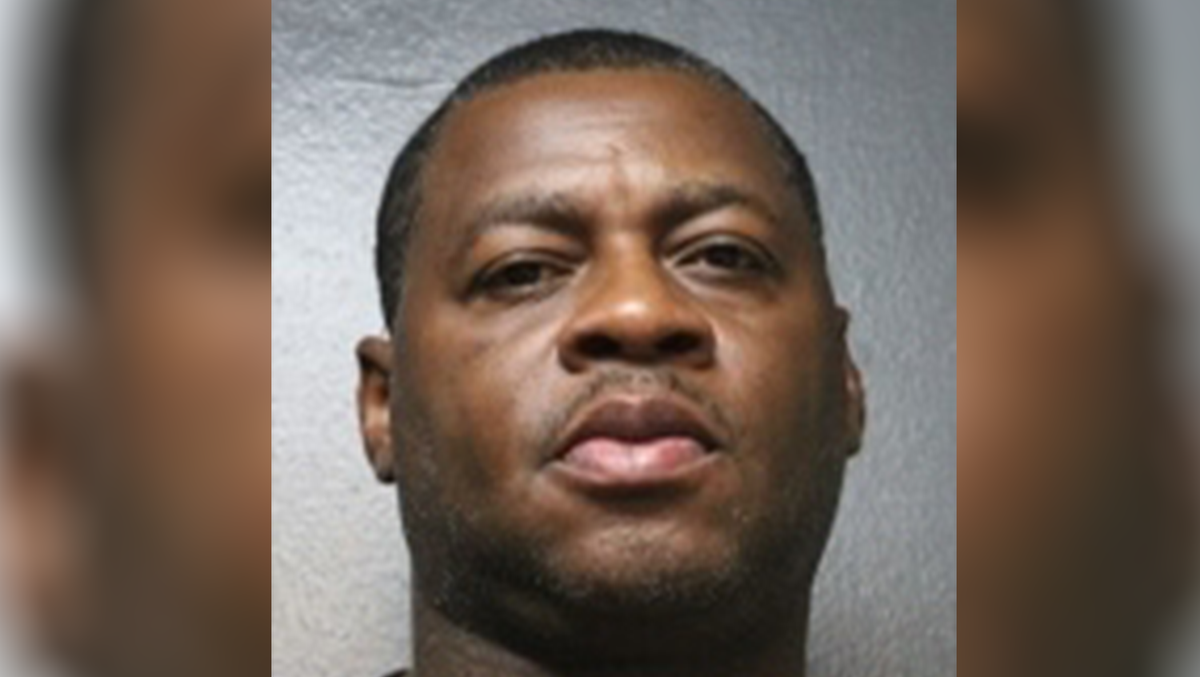 Former Oklahoma basketball star Desmond Mason goes through booking process for fraud charge