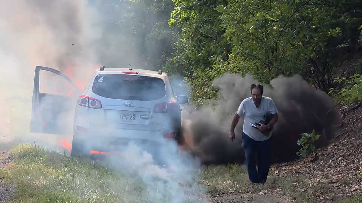 Video: Man walks away as flames consume SUV on side of I-95