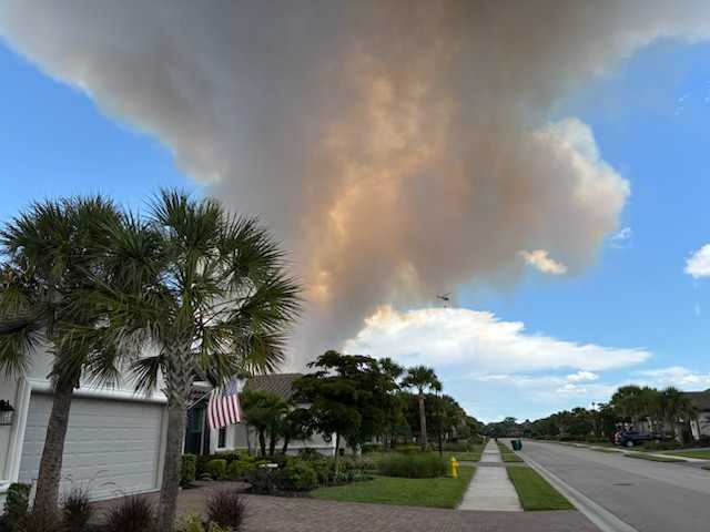 ﻿Plume of smoke from Rifle Range Rd brush fire in Picayune Strand Forest Collier County