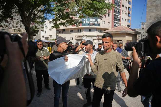 Mourners carry the bodies of two Palestinian girls Zeina Safadi, and her sister Lana, who were killed during an overnight Israeli airstrike that damaged their home, during their funeral in Gaza City, Saturday, June 20, 2026.