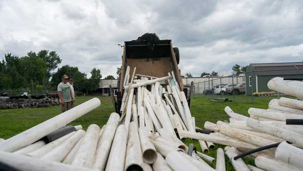 IPEX PVC pipe cleared from the riverbank is dumped at MountainTrue headquarters Wednesday, July 22, 2026, in Alexander, N.C. (AP Photo/Allison Joyce)