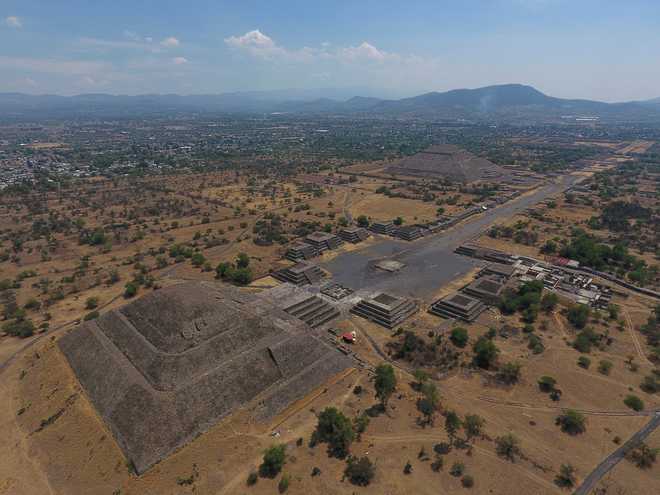 FILE - The Pyramid of the Moon, left, and the Pyramid of the Sun, back right, are seen along with smaller structures lining the Avenue of the Dead, in Teotihuacan, Mexico, March 19, 2020. (AP Photo/Rebecca Blackwell, File)