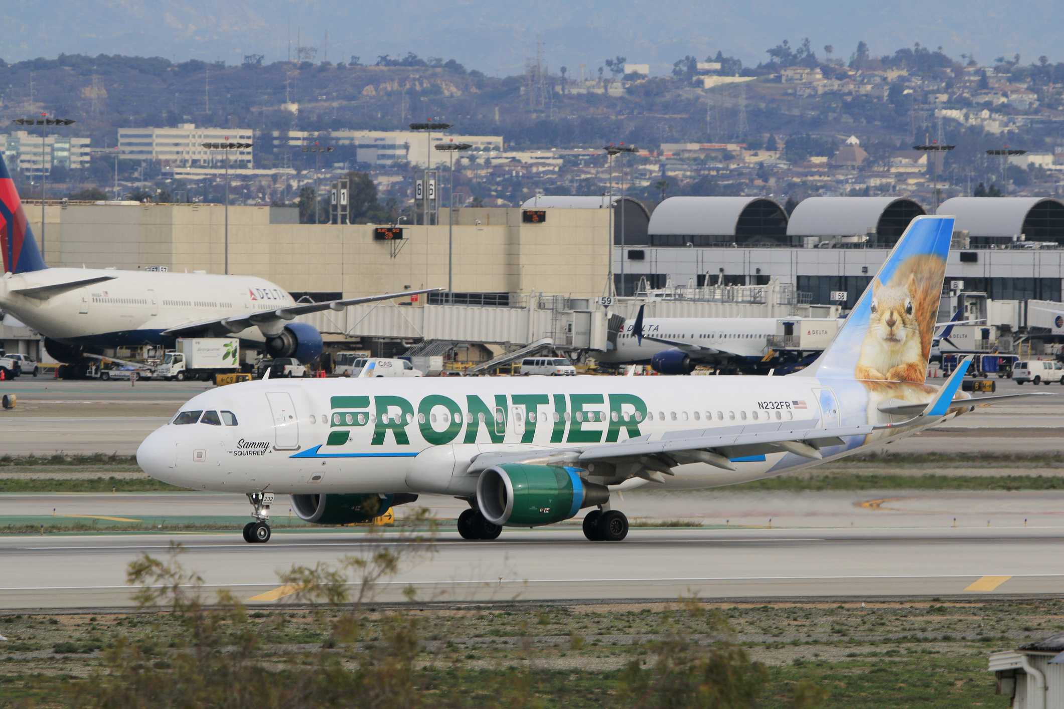 FAA investigates close call between Frontier plane and trucks at LAX: 'It was real close'