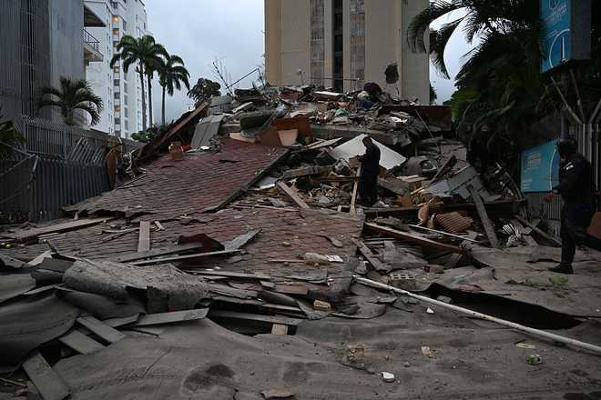A collapsed building is seen following an earthquake in Caracas on June 24, 2026. A magnitude 7.1 earthquake struck Venezuela on Wednesday, the United States Geological Survey (USGS) reported, triggering panic in Caracas, according to AFP journalists. The tremor, which was followed by several aftershocks, was also felt in Colombia. (Photo by Juan BARRETO / AFP via Getty Images)
