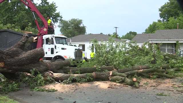 Storm topples 90-year-old pecan tree in Norman, damaging carport with woman underneath