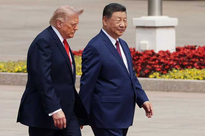BEIJING, CHINA - MAY 14: U.S. President Donald Trump and Chinese President Xi Jinping attend a welcome ceremony at the Great Hall of the People on May 14, 2026 in Beijing, China. President Trump is meeting with President Xi Jinping in Beijing to address the Iran conflict, trade imbalances, and the Taiwan situation while establishing new bilateral boards for economic and AI oversight. (Photo by Alex Wong/Getty Images)